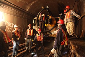 Image: A group of maintenance people conversing.